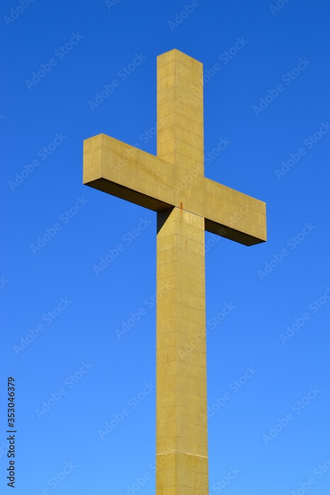 Tall cross on blue sky background
