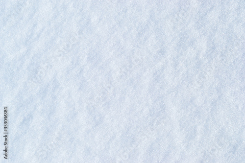 Frosty background of fresh snow texture. Beautiful winter background. Space for text.