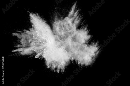 Bizarre forms of  white powder explosion cloud against dark background. Launched white particle splash on black background