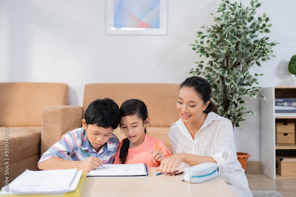 Son and daughter studying online His mother helped teach homework. Son and daughter studying online His mother helped teach homework.