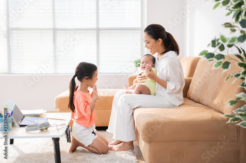 Asian family Relaxing from online learning