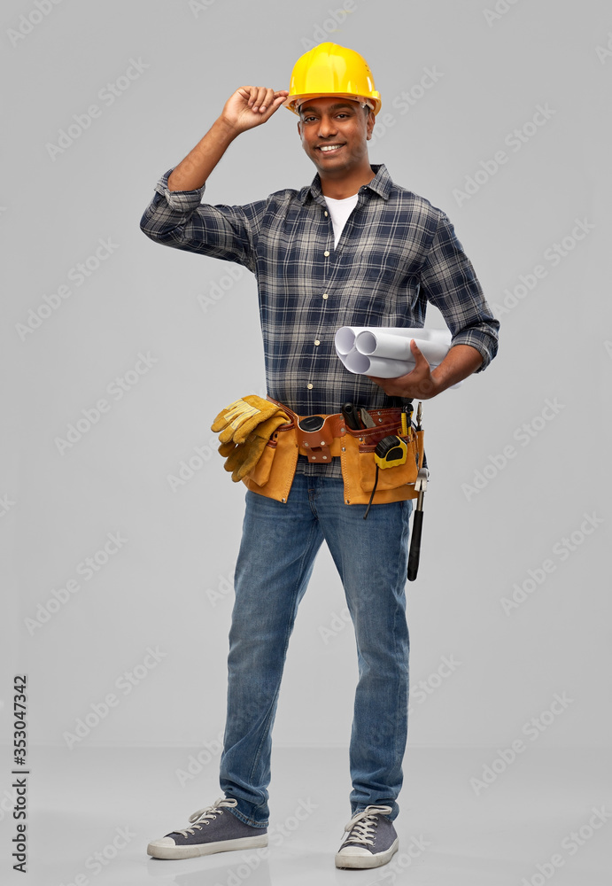 profession, construction and building - happy smiling indian builder in helmet with blueprint over grey background profession, construction and building - happy smiling indian builder in helmet with blueprint over grey background