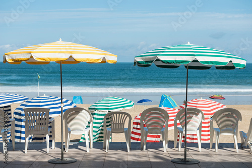 Fototapeta Naklejka Na Ścianę i Meble -  Striped umbrellas on the beach Biarritz, France	