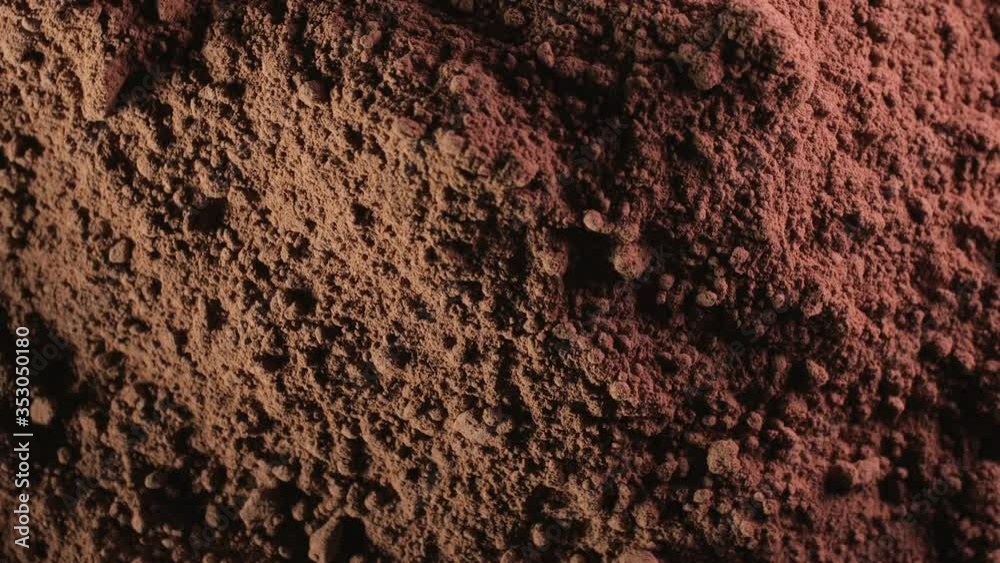 Rotation of cocoa powder texture with approximation. A powder similar to soil, earth or the surface of the moon. Touchdown concept Rotation of cocoa powder texture with approximation. A powder similar to soil, earth or the surface of the moon. Touchdown concept