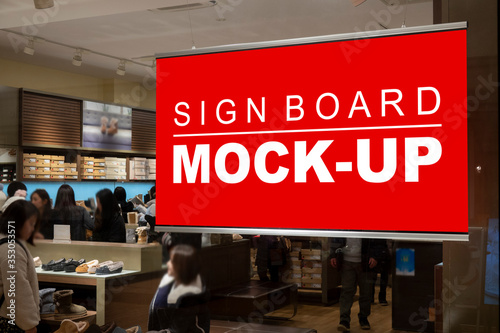 Mock up blank horizontal signboard hanging from ceiling of store