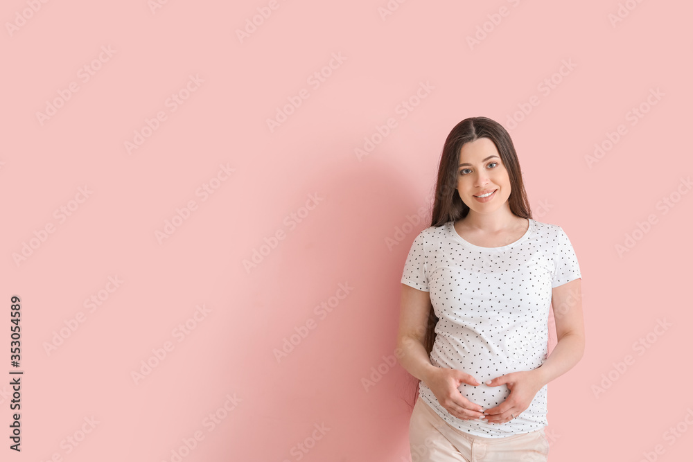 Beautiful pregnant woman on color background Beautiful pregnant woman on color background