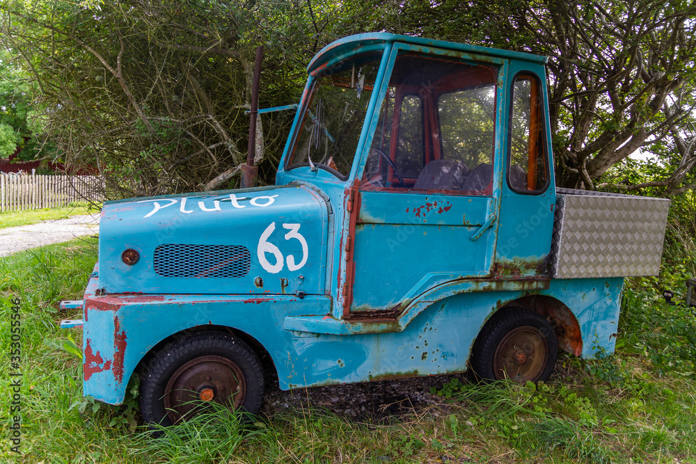 An old abandoned blue two-places car in the village An old abandoned blue two-places car in the village