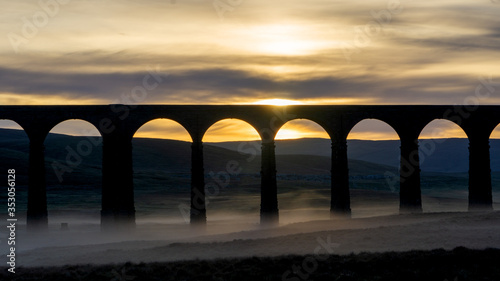 A close view of the arches light by a misty sunrise of the iconic landmark Ribblehead Viaduct in the yorkshire dales national park,yorkshire, england © jmh-photography