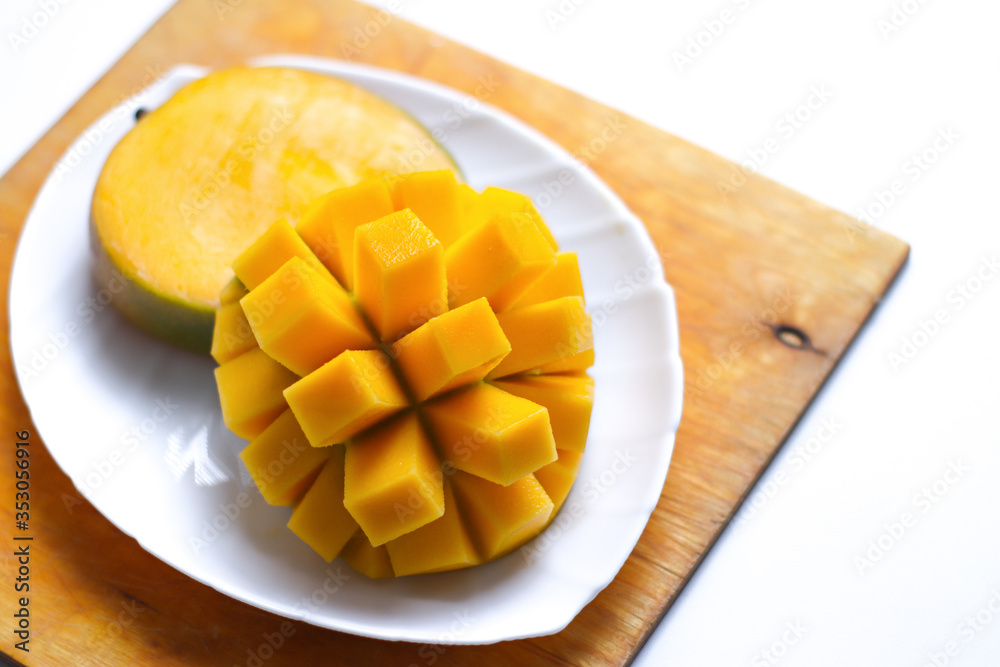 Juicy mango slices on a white plate Juicy mango slices on a white plate