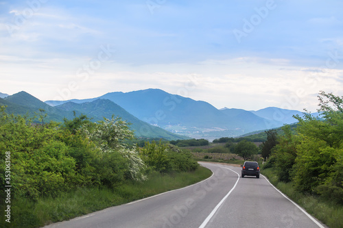 car rides along a country road in the mountains
