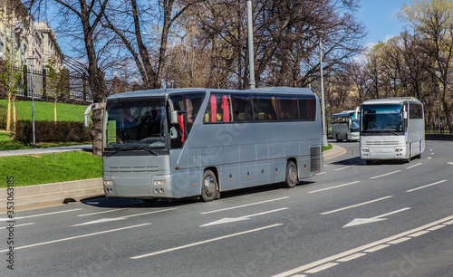 Tour Buses Move On City Street