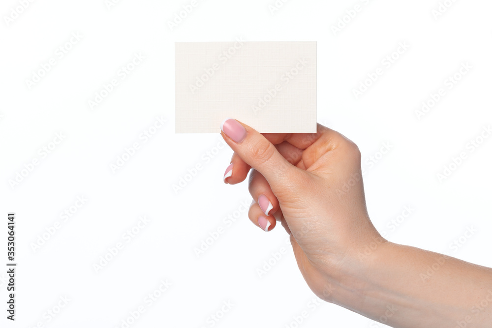 Female hand with blank white business card isolated on white