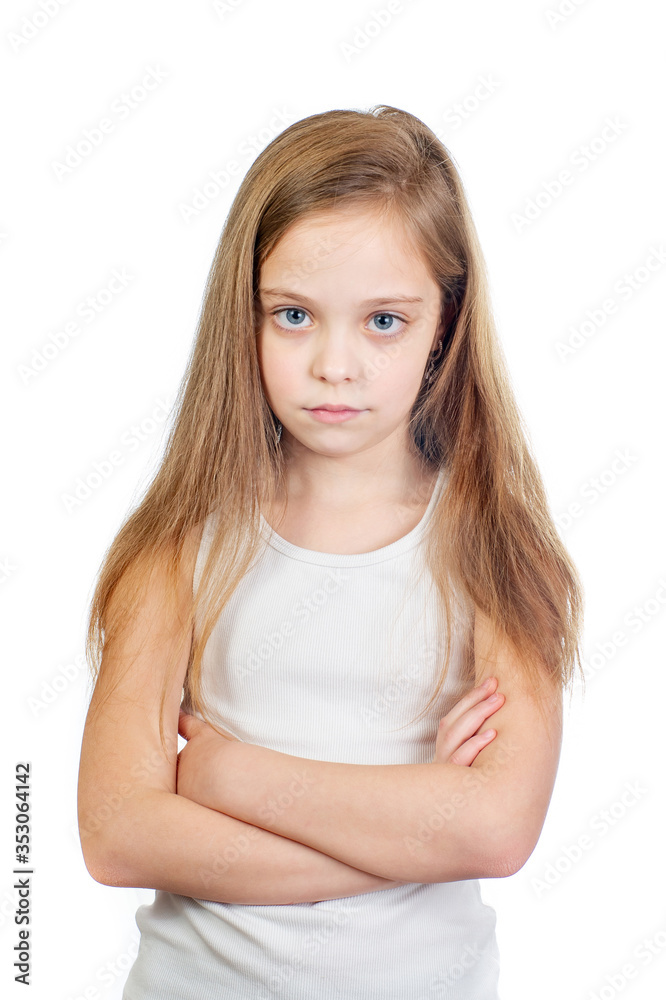 Young cute displeased girl with grey blue eyes, long light brown hair and crossed arms isolated on white background Young cute displeased girl with grey blue eyes, long light brown hair and crossed arms isolated on white background