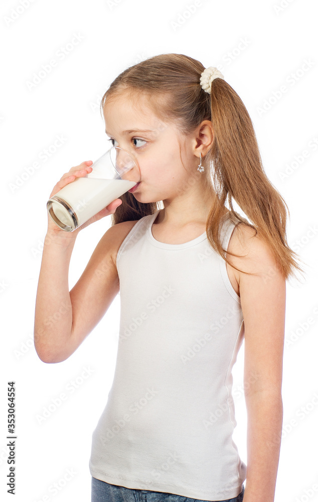 Young cute girl with grey blue eyes and two hair tails drinks milk isolated on white background Young cute girl with grey blue eyes and two hair tails drinks milk isolated on white background