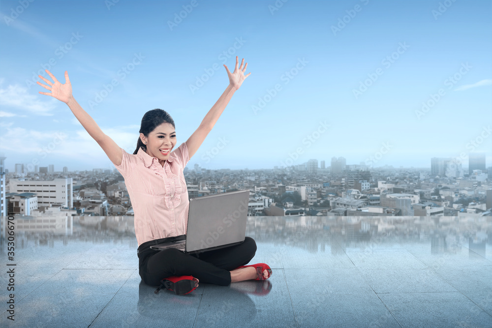 Asian businesswoman sitting and reading news on her laptop Asian businesswoman sitting and reading news on her laptop