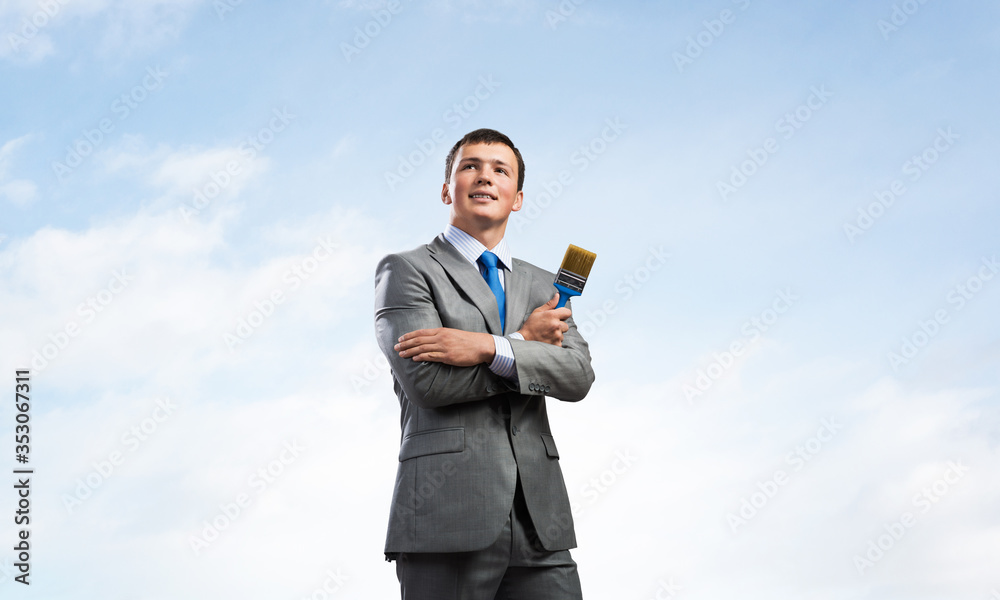 Creative businessman painter holding paintbrush Creative businessman painter holding paintbrush