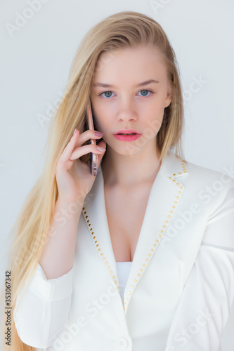 Portrait of beautiful young girl with a mobile telephone in a hand