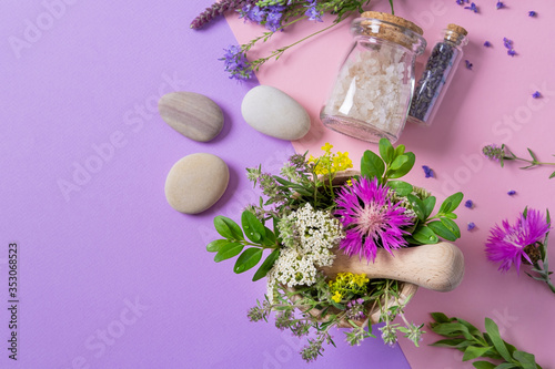 Mortar and pestle with herbs for making homeopathic products. Spa concept. Alternative medicine. Copy space