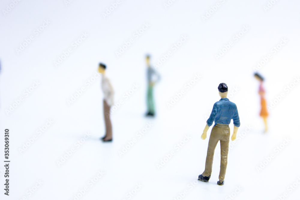 miniature businessmen keep distance away in the public. Social distancing concept avoid COVID-19 coronavirus spreading. miniature businessmen keep distance away in the public. Social distancing concept avoid COVID-19 coronavirus spreading.