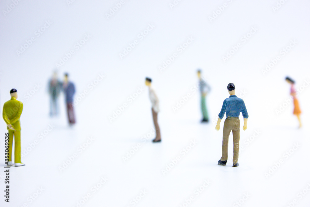 miniature businessmen keep distance away in the public. Social distancing concept avoid COVID-19 coronavirus spreading. miniature businessmen keep distance away in the public. Social distancing concept avoid COVID-19 coronavirus spreading.