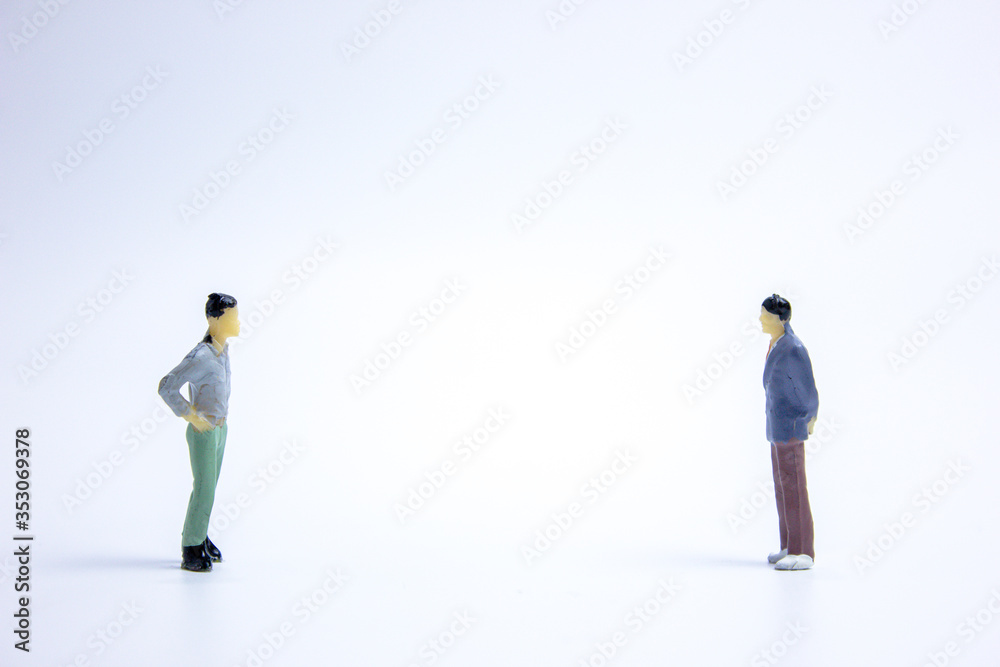 miniature businessmen keep distance away from a person. Social distancing concept avoid COVID-19 coronavirus spreading. miniature businessmen keep distance away from a person. Social distancing concept avoid COVID-19 coronavirus spreading.