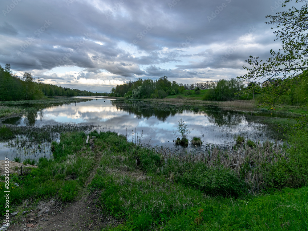 spring landscape with beautiful sky, clouds and tree reflections in the water spring landscape with beautiful sky, clouds and tree reflections in the water