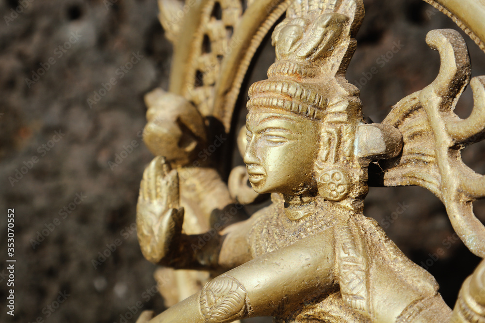 Fototapeta premium Bronze dancing god Sivan against dark background.