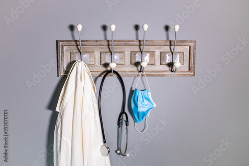 Coat rack of a doctor with a medical mask © Victor