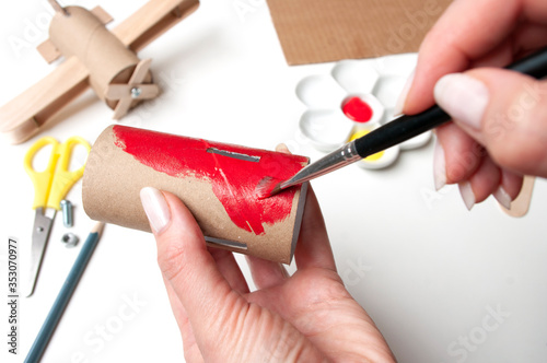 Step by step creating aircrat airplane toy, painting in red part of model made from paper. Diy for kids. Daily activites