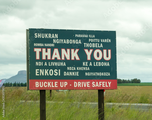 Thank you road sign written in African and foreign languages to buckle up and drive safely in South Africa concept road safety 