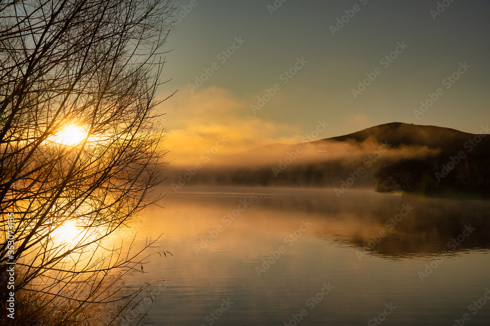 A dramatic sunrise with low cloud and mist over the small lake in Twizel New Zealand A dramatic sunrise with low cloud and mist over the small lake in Twizel New Zealand