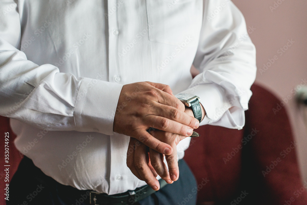 businessman checking time on his wrist watch, man putting clock on hand, groom getting ready in the morning businessman checking time on his wrist watch, man putting clock on hand, groom getting ready in the morning