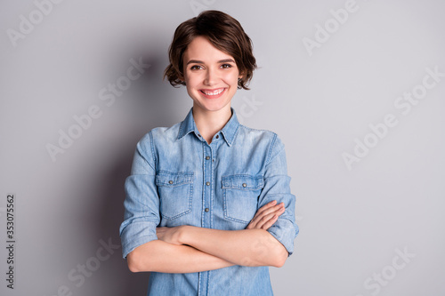 Photo of attractive business lady wavy bobbed hairdo arms crossed self-confident chief worker beaming white teeth smile wear casual denim shirt isolated grey color background photo