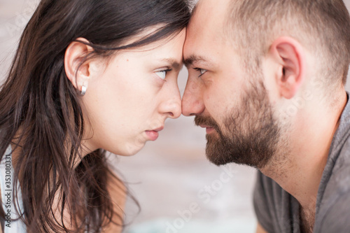 Close up of husband and wife looking into each other eyes in the morning.