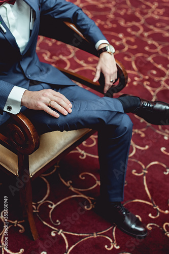 Portrait of a businessman sitting in arm chair © Mykola