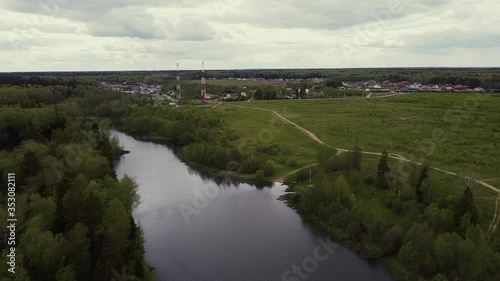 Aerial: Country landscape and flying over a lake in the nearest suburb. 
New Moscow area near Kamenka village, Russia.
Color graded.