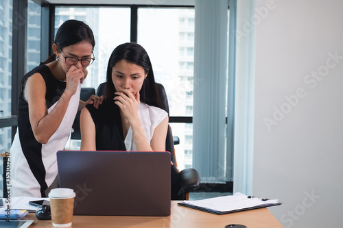 business woman talking to her colleague
Senior business women and young female discuss online project look at pc screen and teamwork on computer task