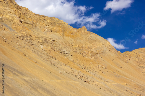 Barren mountains against a blue sky on a sunny day in the Spiti Valley