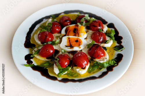 mozzarella - tomatoes in olive oil and balsamic vinegar and basil and cooked egg