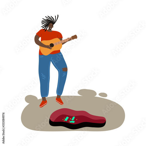 Black man street atrist playing guitar during performance on street
