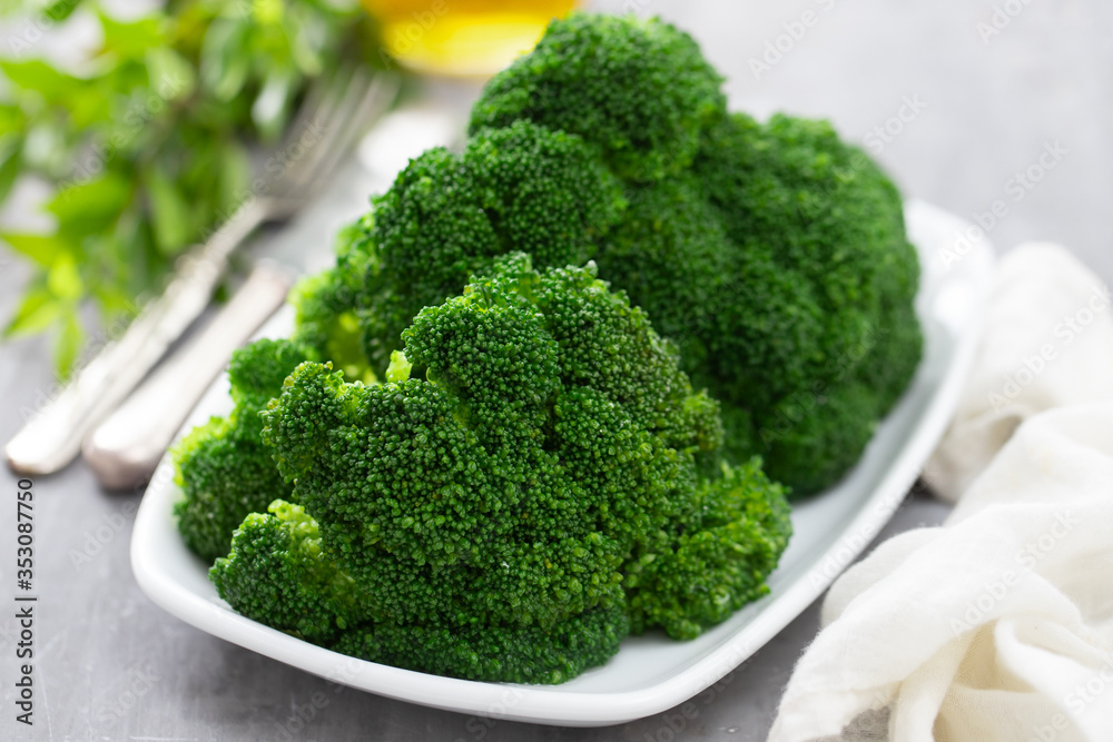 boiled broccoli on white dish on ceramic background boiled broccoli on white dish on ceramic background