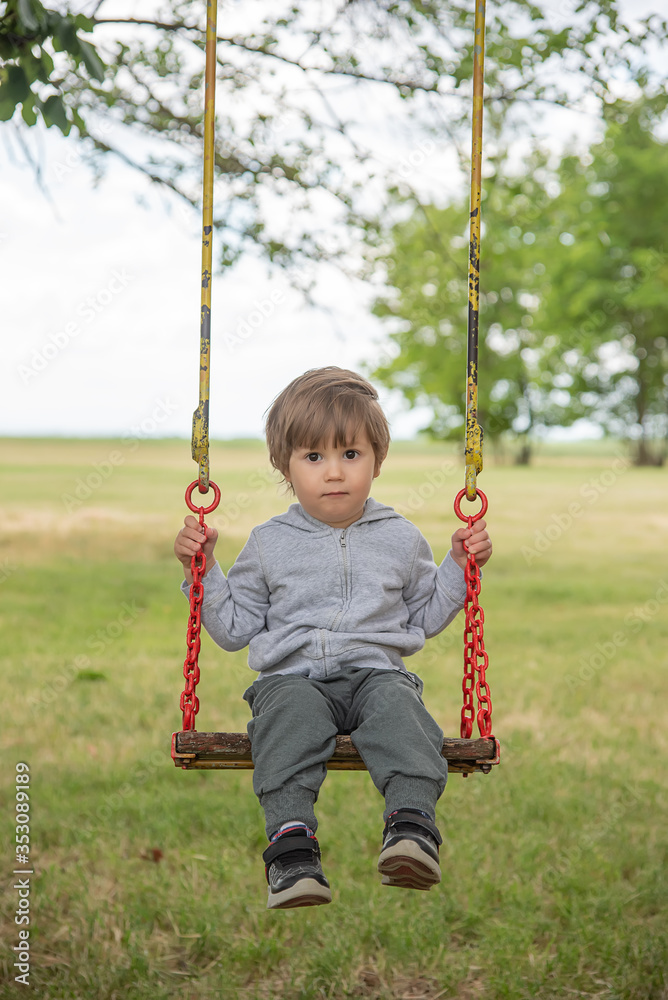 Happy beautiful child on swing in nature Happy beautiful child on swing in nature