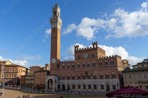 View of the famous " Piazza del Campo" ( Square of Campo) and "Palazzo Pubblico" ( Public Palace) in the city of Siena, Tuscany, Italy