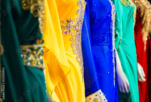 Beautiful, colourful, traditional evening dresses, with intricate detail on display