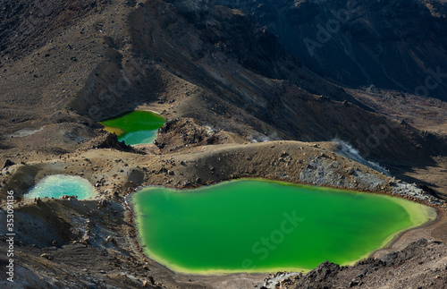 The greenstone-hued emerald lakes of Tongariro Alpine Crossing in winter. The small lake is frozen.