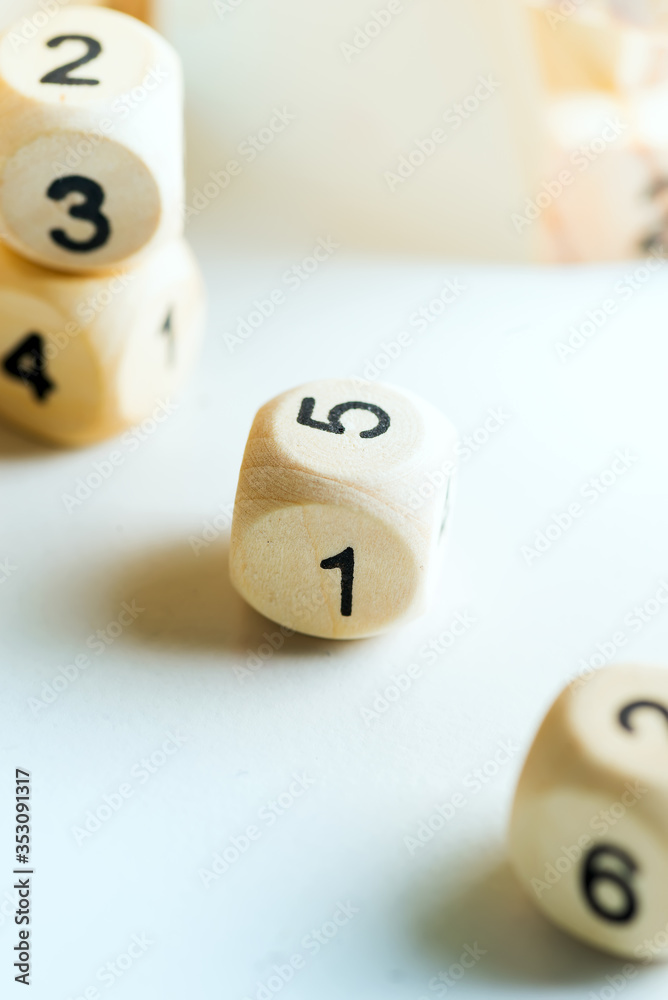 Wooden cubes with numbers on a light grey background. Dice game concept. Wooden cubes with numbers on a light grey background. Dice game concept.