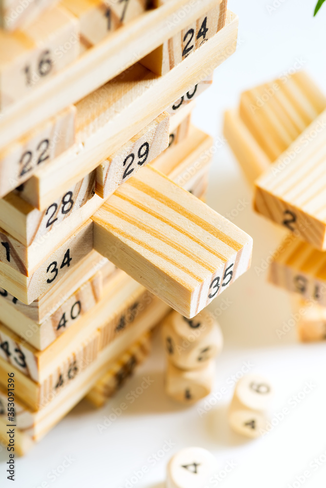 Piramyd from wooden blocks with numbers on a white background. Jenga