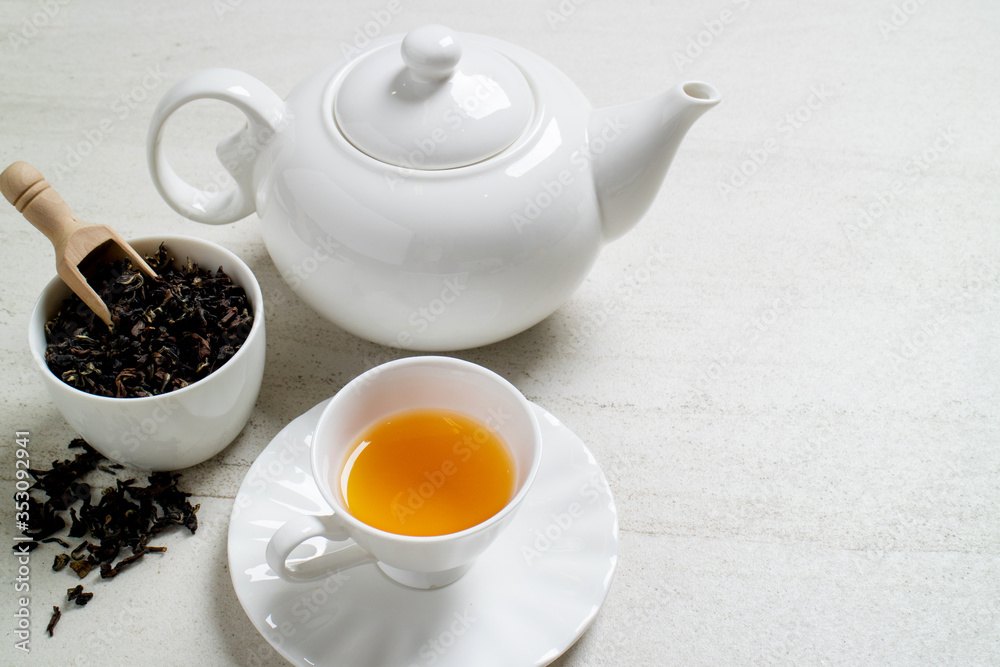 Cup with tea and teapot on white stone table.Top view with copy space. Cup with tea and teapot on white stone table.Top view with copy space.