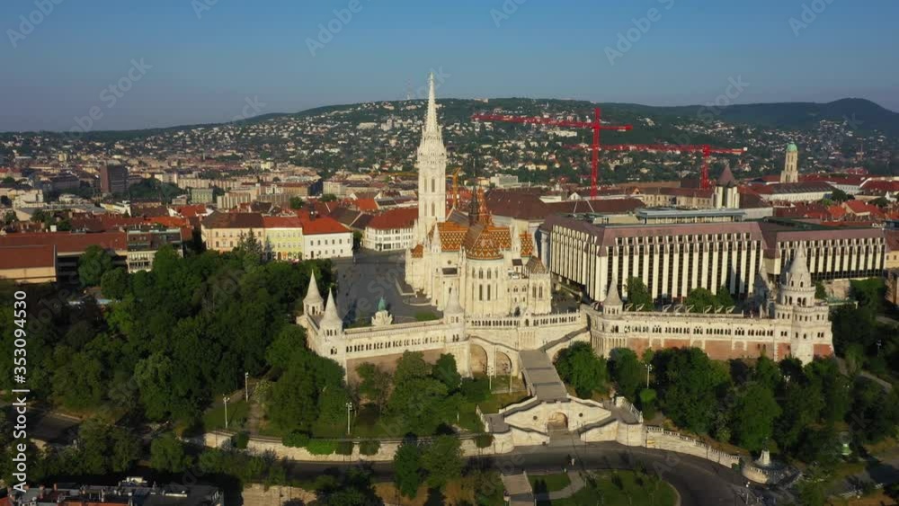 Drone flies slowly right at the Fisherman's Bastion and Matthias Church in the early morning at spring time and clear weather high altitude. Budapest, Hungary