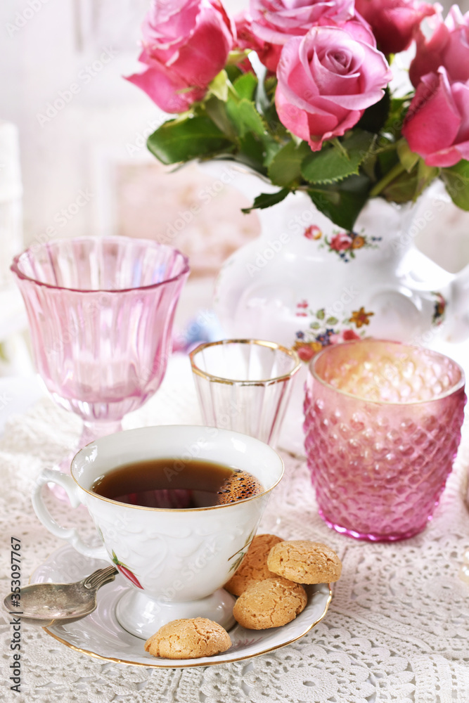 cup of coffee and italian cookies on the table with pink roses cup of coffee and italian cookies on the table with pink roses